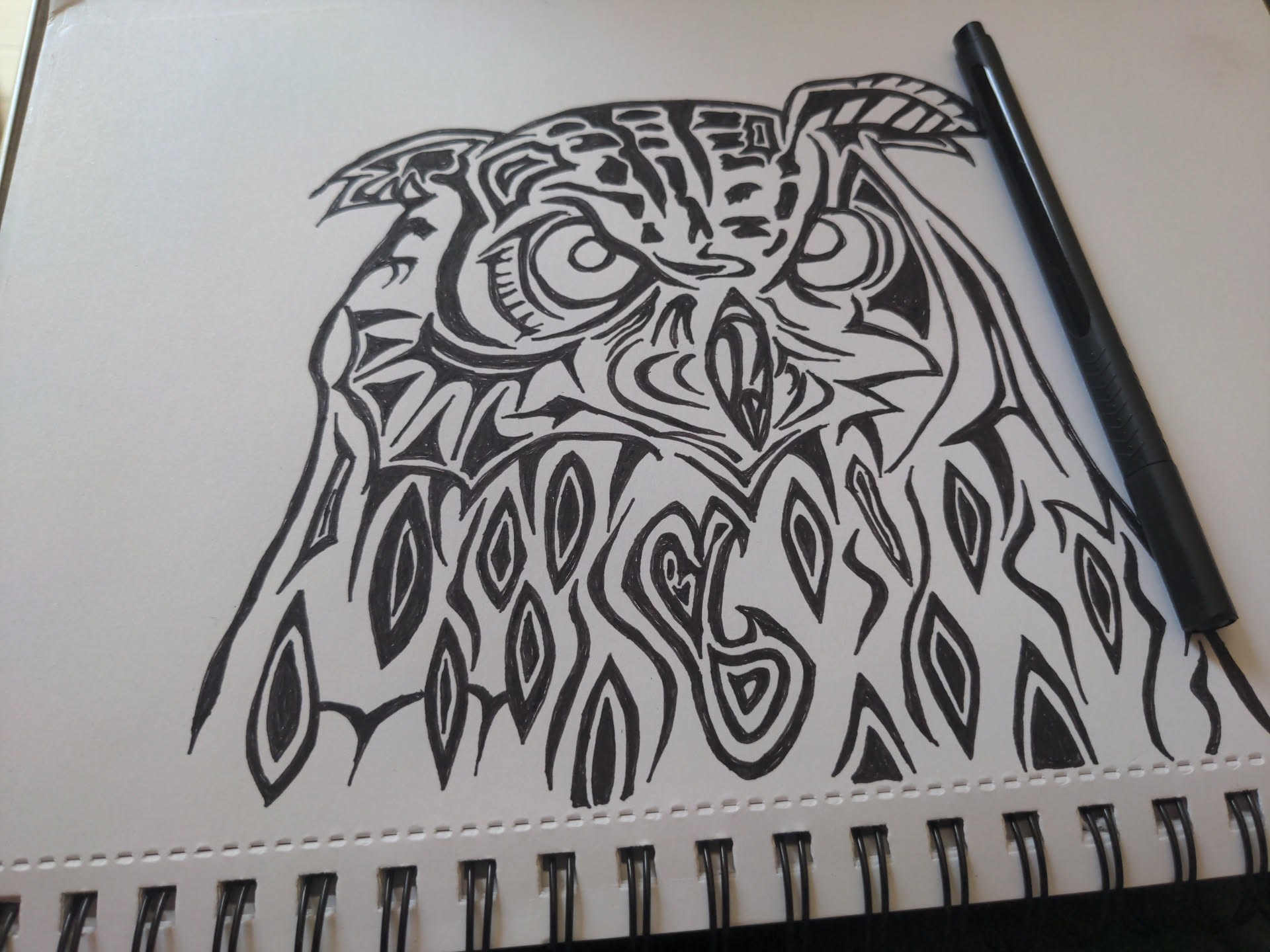 Stylised black ink drawing of an owl